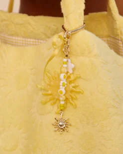 Porte-clé doré avec charms soleil et cœur